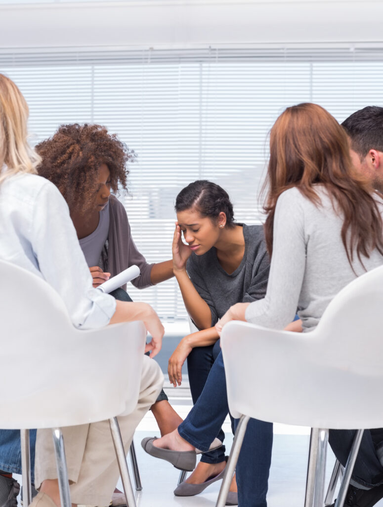 People participate in group therapy at an alcohol rehab center.