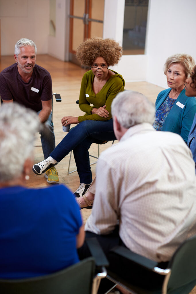 People participate in group therapy at an alcohol rehab center.