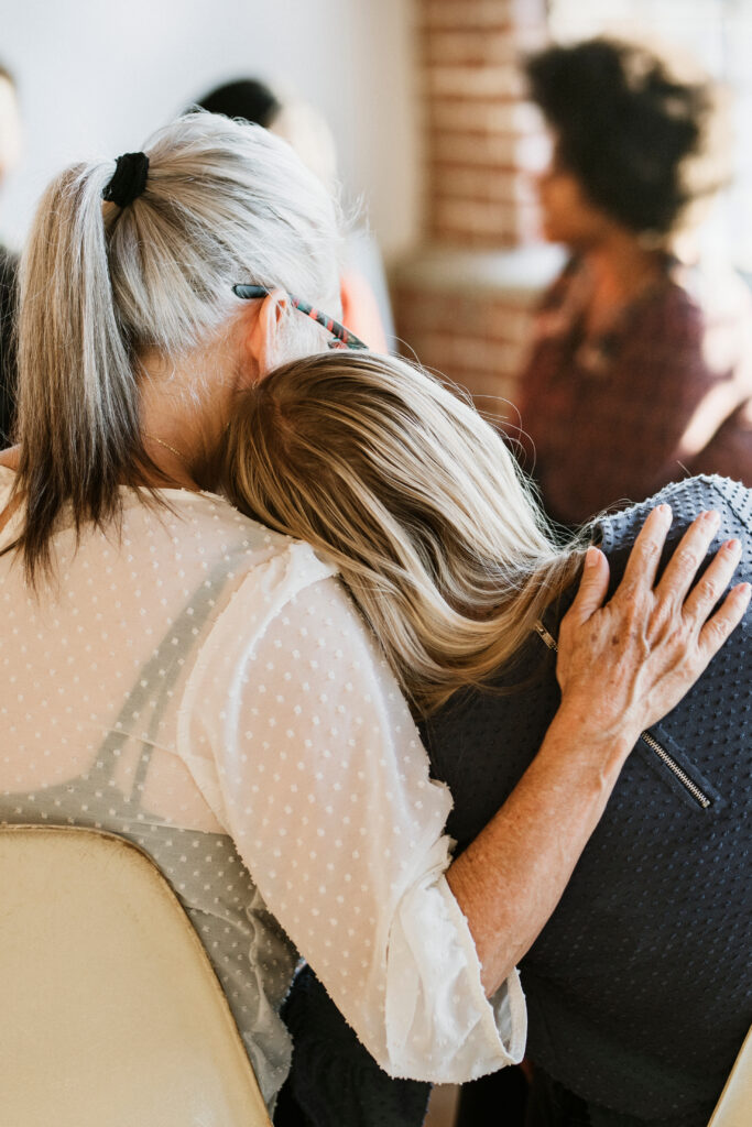 People support each other while participating in group therapy at an alcohol rehab center.