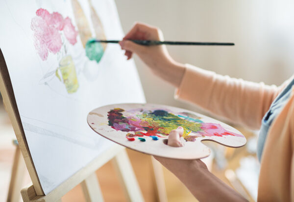 A person participates in art therapy, a form of creative addiction treatment.