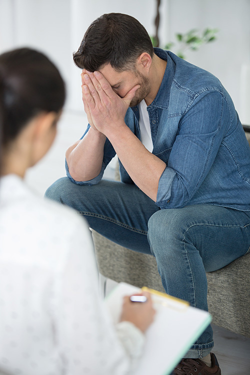 A man participates in therapy as part of gambling addiction treatment.